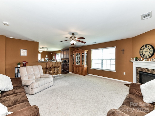 1374 Kent Downs Ave SW, Concord, NC 28027 - carpeted living area with plenty of natural light, ceiling fan, and a high end fireplace