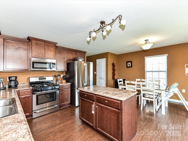1374 Kent Downs Ave SW, Concord, NC 28027 - kitchen featuring stainless steel appliances, dark wood finished floors, light countertops, and a center island