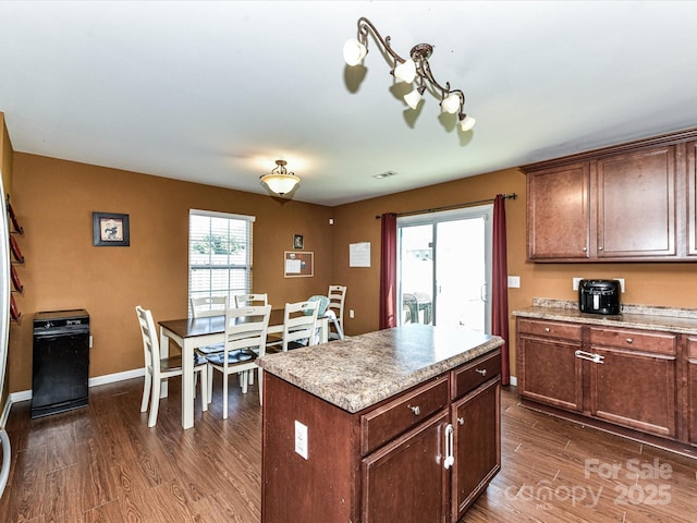 1374 Kent Downs Ave SW, Concord, NC 28027 - kitchen with dark wood-style flooring, light countertops, and a center island