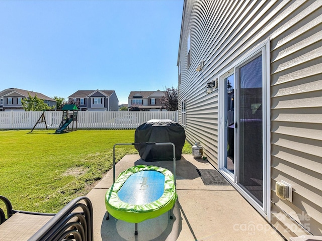 1374 Kent Downs Ave SW, Concord, NC 28027 - fenced backyard with a playground, a grill, a patio, and a residential view