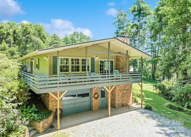 975 Buchanan Loop, Sylva, NC 28779 - view of front facade with a chimney, driveway, brick siding, and an attached garage