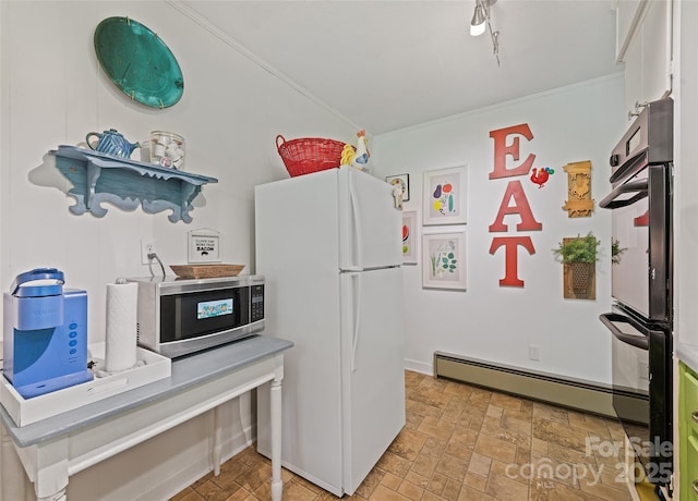 975 Buchanan Loop, Sylva, NC 28779 - kitchen with freestanding refrigerator, stainless steel microwave, a baseboard heating unit, crown molding, and double wall oven