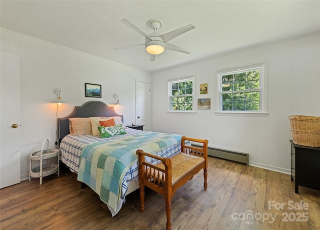 975 Buchanan Loop, Sylva, NC 28779 - bedroom featuring hardwood / wood-style flooring, a baseboard heating unit, and ceiling fan