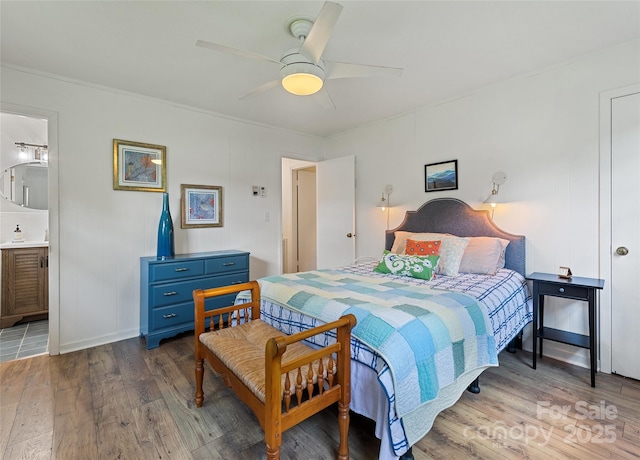975 Buchanan Loop, Sylva, NC 28779 - bedroom with wood finished floors, a ceiling fan, and connected bathroom