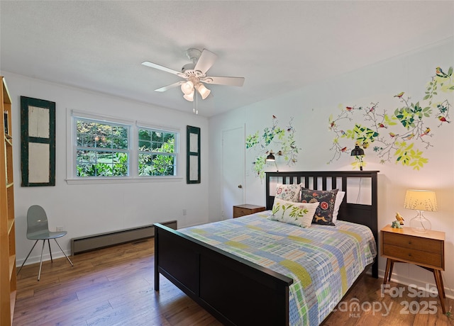 975 Buchanan Loop, Sylva, NC 28779 - bedroom with a baseboard radiator, wood finished floors, and ceiling fan