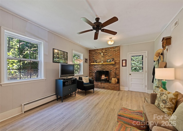 975 Buchanan Loop, Sylva, NC 28779 - living area with a baseboard heating unit, light wood-type flooring, a fireplace, ceiling fan, and ornamental molding