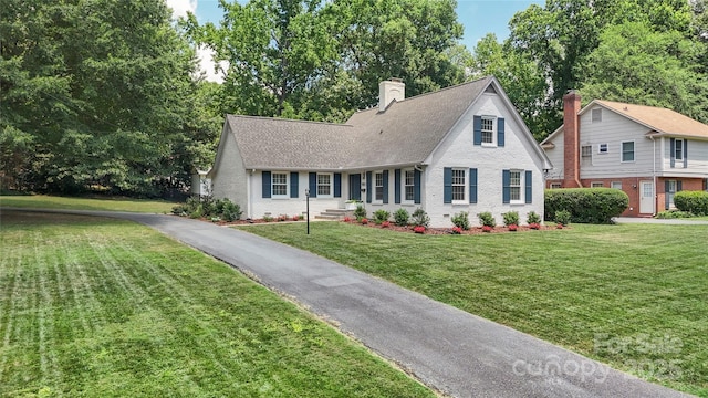 4201 Tyndale Ave, Charlotte, NC 28210 - view of front of house featuring a front lawn, brick siding, roof with shingles, and a chimney
