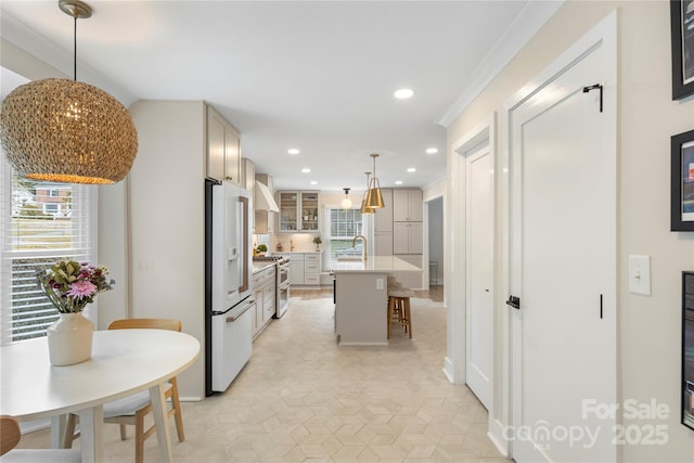 4201 Tyndale Ave, Charlotte, NC 28210 - kitchen featuring white fridge with ice dispenser, range with two ovens, a breakfast bar, recessed lighting, and glass insert cabinets
