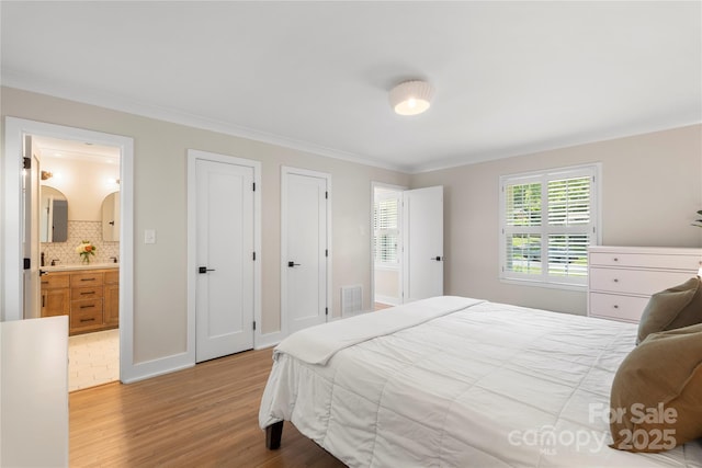 4201 Tyndale Ave, Charlotte, NC 28210 - bedroom featuring light wood-style floors, crown molding, and ensuite bathroom