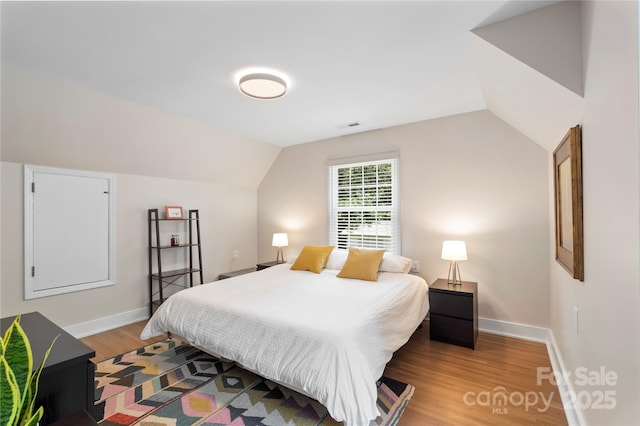 4201 Tyndale Ave, Charlotte, NC 28210 - bedroom with light wood finished floors and vaulted ceiling
