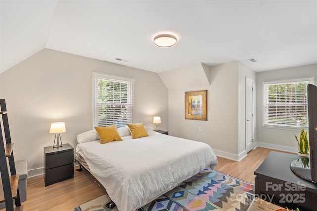 4201 Tyndale Ave, Charlotte, NC 28210 - bedroom featuring light wood finished floors, multiple windows, and vaulted ceiling