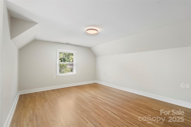 4201 Tyndale Ave, Charlotte, NC 28210 - additional living space featuring light wood-style flooring and vaulted ceiling