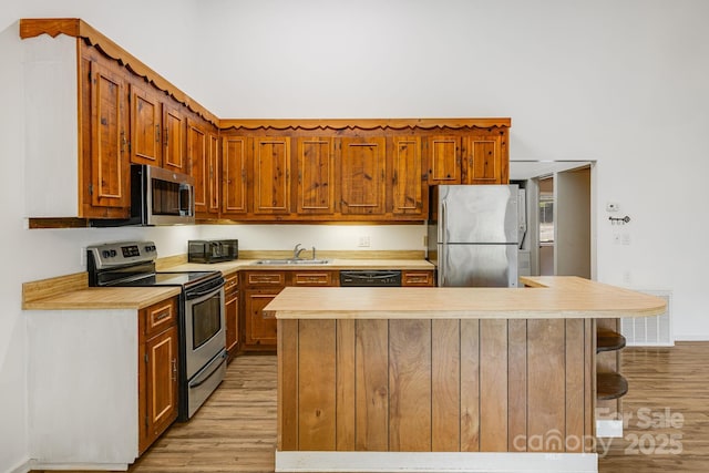 263 Shannons Walk, Lake Lure, NC 28746 - kitchen featuring appliances with stainless steel finishes, light wood-style floors, and light countertops