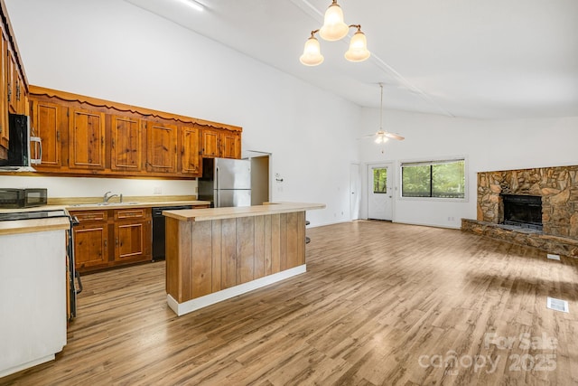 263 Shannons Walk, Lake Lure, NC 28746 - kitchen featuring black appliances, light countertops, high vaulted ceiling, open floor plan, and a fireplace