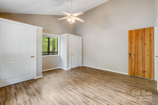 263 Shannons Walk, Lake Lure, NC 28746 - unfurnished bedroom featuring wood finished floors, high vaulted ceiling, and ceiling fan