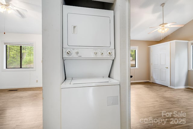 263 Shannons Walk, Lake Lure, NC 28746 - laundry area with stacked washer / dryer, a ceiling fan, wood finished floors, and plenty of natural light