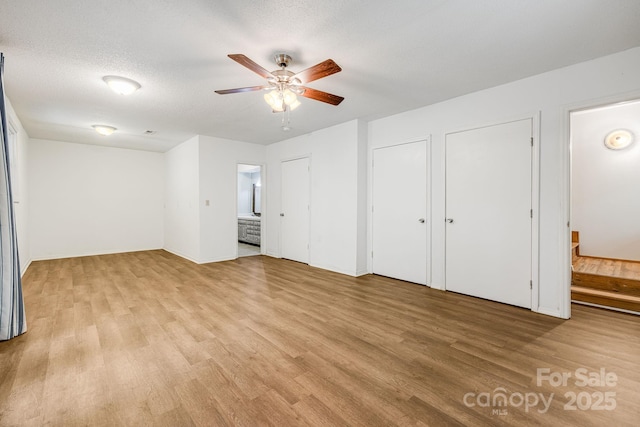 263 Shannons Walk, Lake Lure, NC 28746 - unfurnished bedroom featuring light wood-style flooring, two closets, and connected bathroom