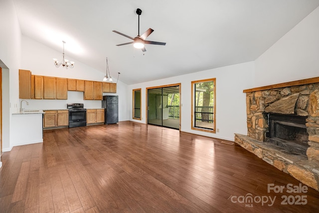 263 Shannons Walk, Lake Lure, NC 28746 - unfurnished living room featuring a chandelier, a ceiling fan, high vaulted ceiling, dark wood-style floors, and a stone fireplace