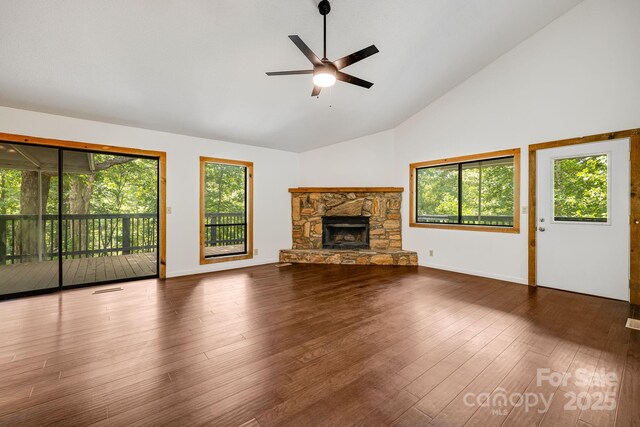 263 Shannons Walk, Lake Lure, NC 28746 - unfurnished living room featuring healthy amount of natural light, ceiling fan, high vaulted ceiling, a stone fireplace, and wood finished floors