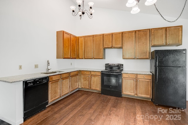 263 Shannons Walk, Lake Lure, NC 28746 - kitchen featuring black appliances, a chandelier, dark wood-style flooring, brown cabinetry, and a towering ceiling
