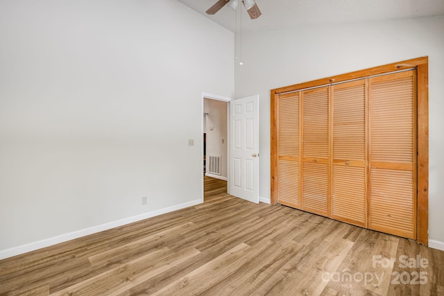 263 Shannons Walk, Lake Lure, NC 28746 - unfurnished bedroom with wood finished floors, high vaulted ceiling, ceiling fan, and a closet