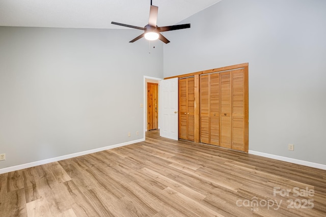 263 Shannons Walk, Lake Lure, NC 28746 - unfurnished bedroom featuring a towering ceiling, light wood-type flooring, ceiling fan, and multiple closets
