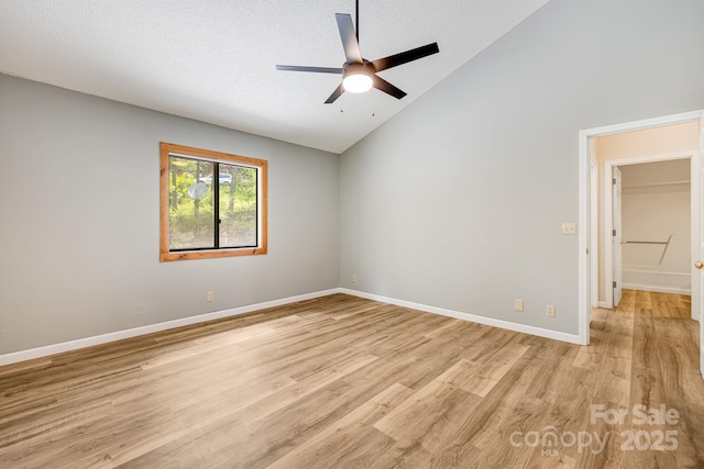 263 Shannons Walk, Lake Lure, NC 28746 - empty room with light wood-style flooring, ceiling fan, a textured ceiling, and high vaulted ceiling