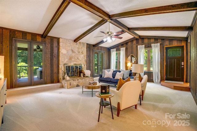 924 Holly Rd, Rock Hill, SC 29730 - living area featuring carpet floors, wooden walls, french doors, a stone fireplace, and a ceiling fan