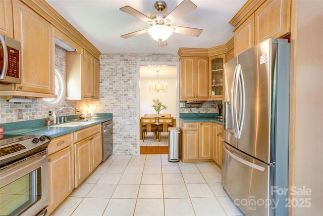 924 Holly Rd, Rock Hill, SC 29730 - kitchen with appliances with stainless steel finishes, light brown cabinetry, light tile patterned floors, glass insert cabinets, and tasteful backsplash