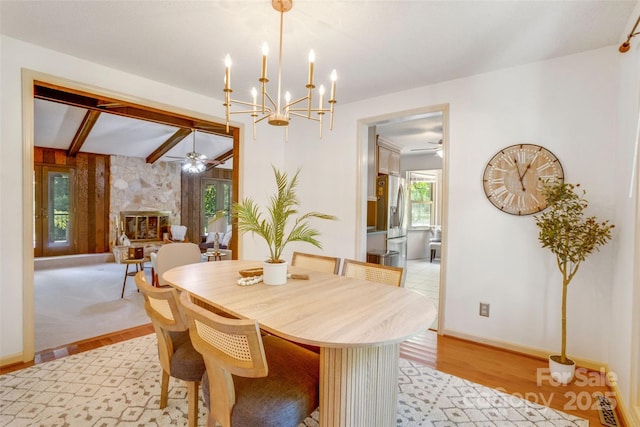 924 Holly Rd, Rock Hill, SC 29730 - dining room with ceiling fan, light wood finished floors, a fireplace, beam ceiling, and a chandelier