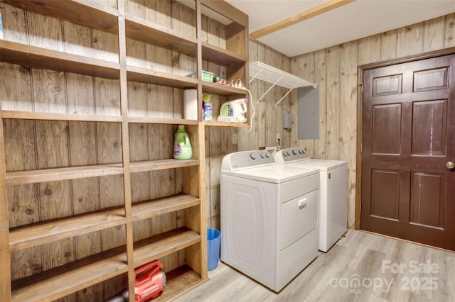924 Holly Rd, Rock Hill, SC 29730 - washroom featuring washing machine and dryer, light wood-type flooring, and wood walls