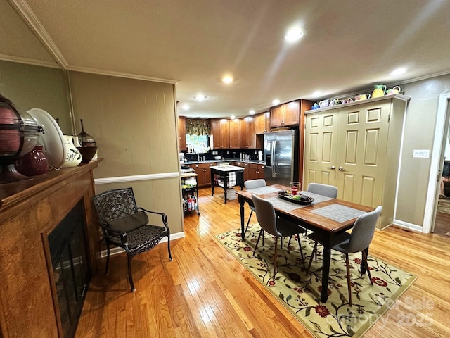 25 Norman Rd, Fletcher, NC 28732 - dining space featuring crown molding, light wood-style flooring, recessed lighting, and a fireplace