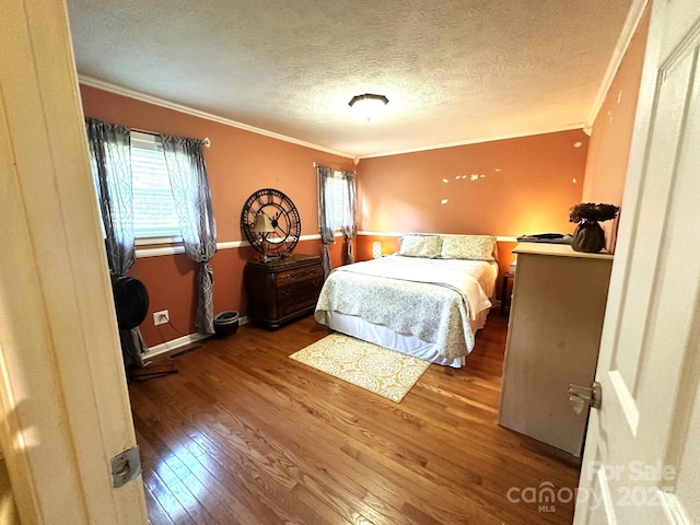 25 Norman Rd, Fletcher, NC 28732 - bedroom with crown molding, hardwood / wood-style flooring, multiple windows, and a textured ceiling
