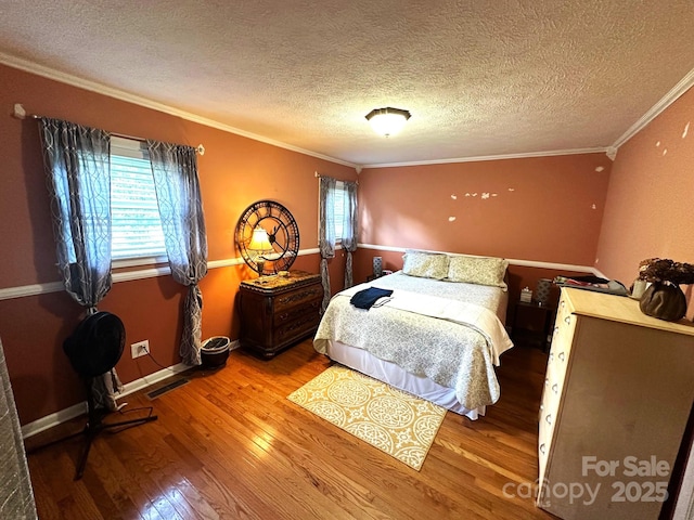 25 Norman Rd, Fletcher, NC 28732 - bedroom with ornamental molding, multiple windows, wood finished floors, and a textured ceiling