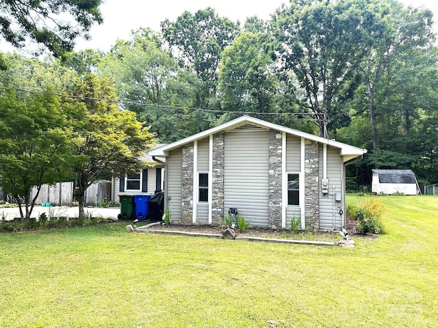 25 Norman Rd, Fletcher, NC 28732 - view of front facade featuring stone siding, a front lawn, and a shed