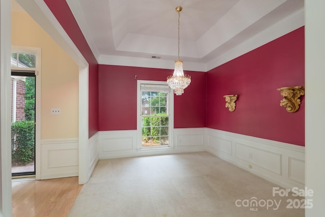 10511 Pullengreen Dr, Charlotte, NC 28277 - unfurnished dining area featuring plenty of natural light, a chandelier, a wainscoted wall, and a tray ceiling