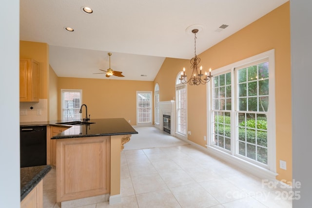10511 Pullengreen Dr, Charlotte, NC 28277 - kitchen with dishwasher, light brown cabinetry, vaulted ceiling, open floor plan, and a peninsula