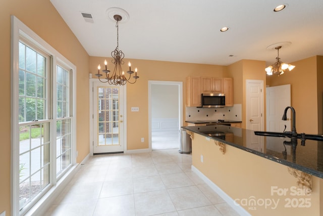 10511 Pullengreen Dr, Charlotte, NC 28277 - kitchen featuring a chandelier, stainless steel microwave, healthy amount of natural light, light brown cabinets, and recessed lighting