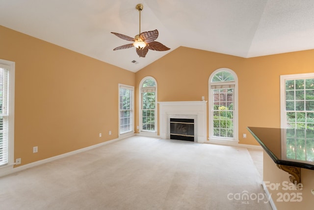 10511 Pullengreen Dr, Charlotte, NC 28277 - unfurnished living room featuring ceiling fan, light carpet, vaulted ceiling, a premium fireplace, and healthy amount of natural light
