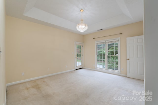 10511 Pullengreen Dr, Charlotte, NC 28277 - carpeted empty room with a chandelier and a raised ceiling