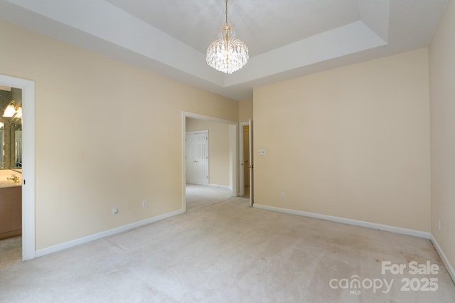10511 Pullengreen Dr, Charlotte, NC 28277 - spare room with a chandelier, carpet floors, and a tray ceiling