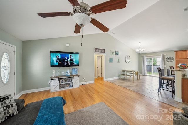 239 Shellbank Dr, Sneads Ferry, NC 28460 - living room featuring a chandelier, vaulted ceiling, light wood-style flooring, and ceiling fan