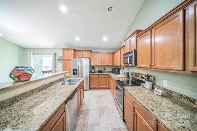239 Shellbank Dr, Sneads Ferry, NC 28460 - kitchen featuring stainless steel appliances, light stone counters, vaulted ceiling, brown cabinetry, and recessed lighting