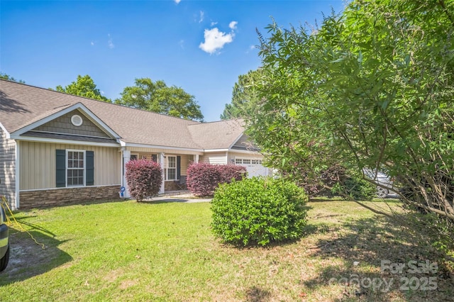 239 Shellbank Dr, Sneads Ferry, NC 28460 - view of front of house with stone siding, a front lawn, and an attached garage