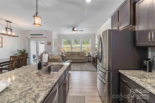 1076 Chicory Trce, Clover, SC 29710 - kitchen with ornamental molding, dark brown cabinetry, ceiling fan, light wood-style flooring, and open floor plan