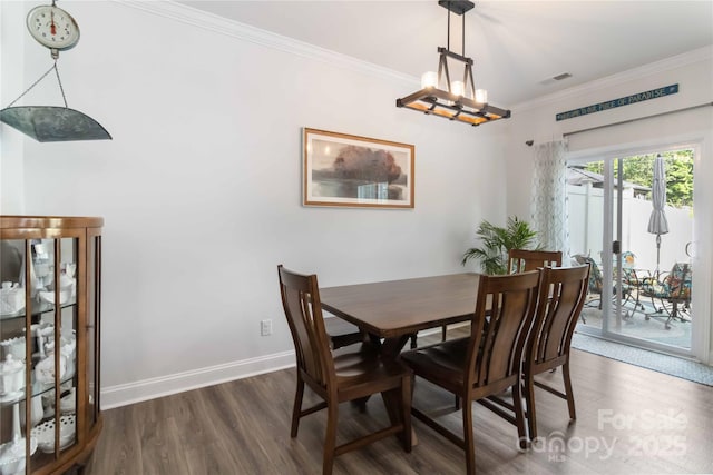 1076 Chicory Trce, Clover, SC 29710 - dining space featuring wood finished floors, ornamental molding, and a chandelier