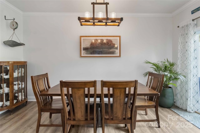 1076 Chicory Trce, Clover, SC 29710 - dining area featuring wood finished floors, a chandelier, and ornamental molding