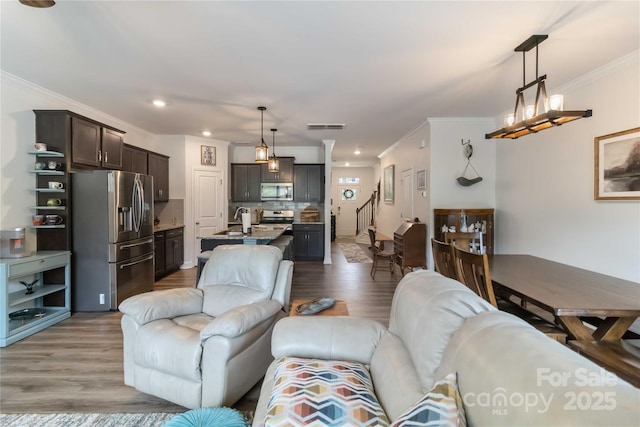 1076 Chicory Trce, Clover, SC 29710 - living room with crown molding, wood finished floors, stairs, and recessed lighting