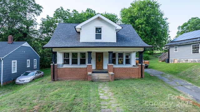 242 8th Avenue Dr SW, Hickory, NC 28602 - view of front of house with covered porch, a front yard, a shingled roof, and brick siding