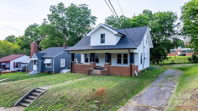 242 8th Avenue Dr SW, Hickory, NC 28602 - bungalow featuring a porch, a shingled roof, asphalt driveway, and entry steps